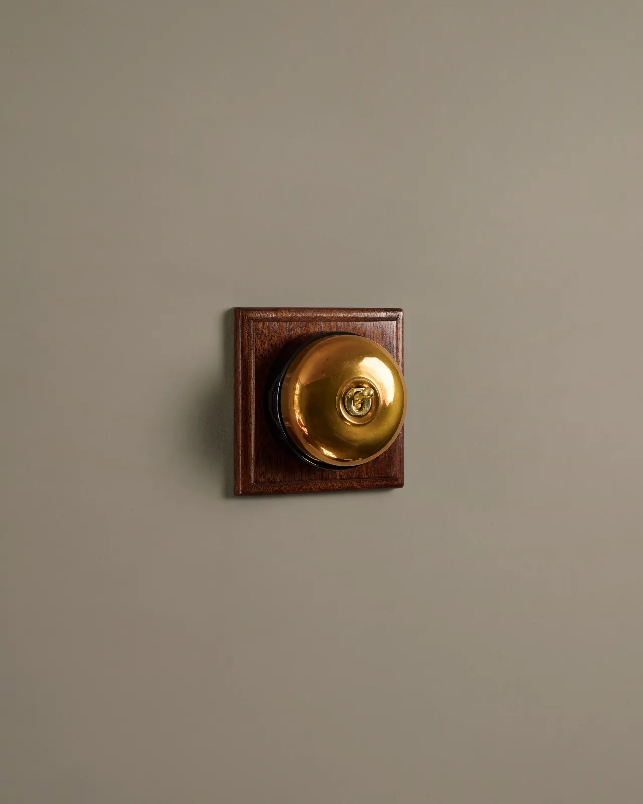 A deVOL Heirloom Brass Dolly Toggle Switches fitted to a Mahogany Finish pattress.