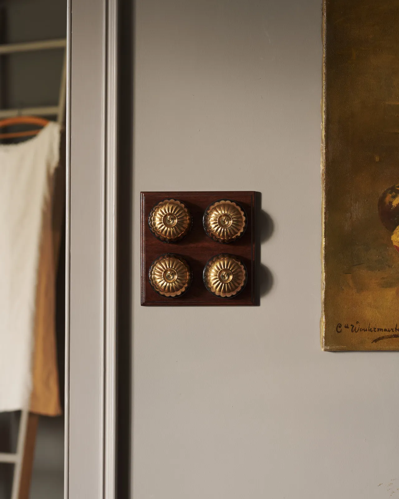 A bank of four Aged Brass Jelly Toggle Switches fitted to a richly stained Sapele pattress. 