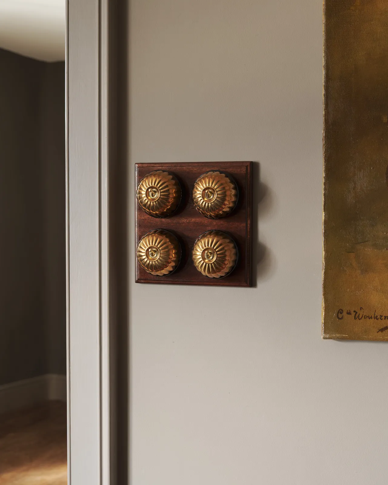 A bank of four Aged Brass Jelly Toggle Switches fitted to a richly stained Sapele pattress. 