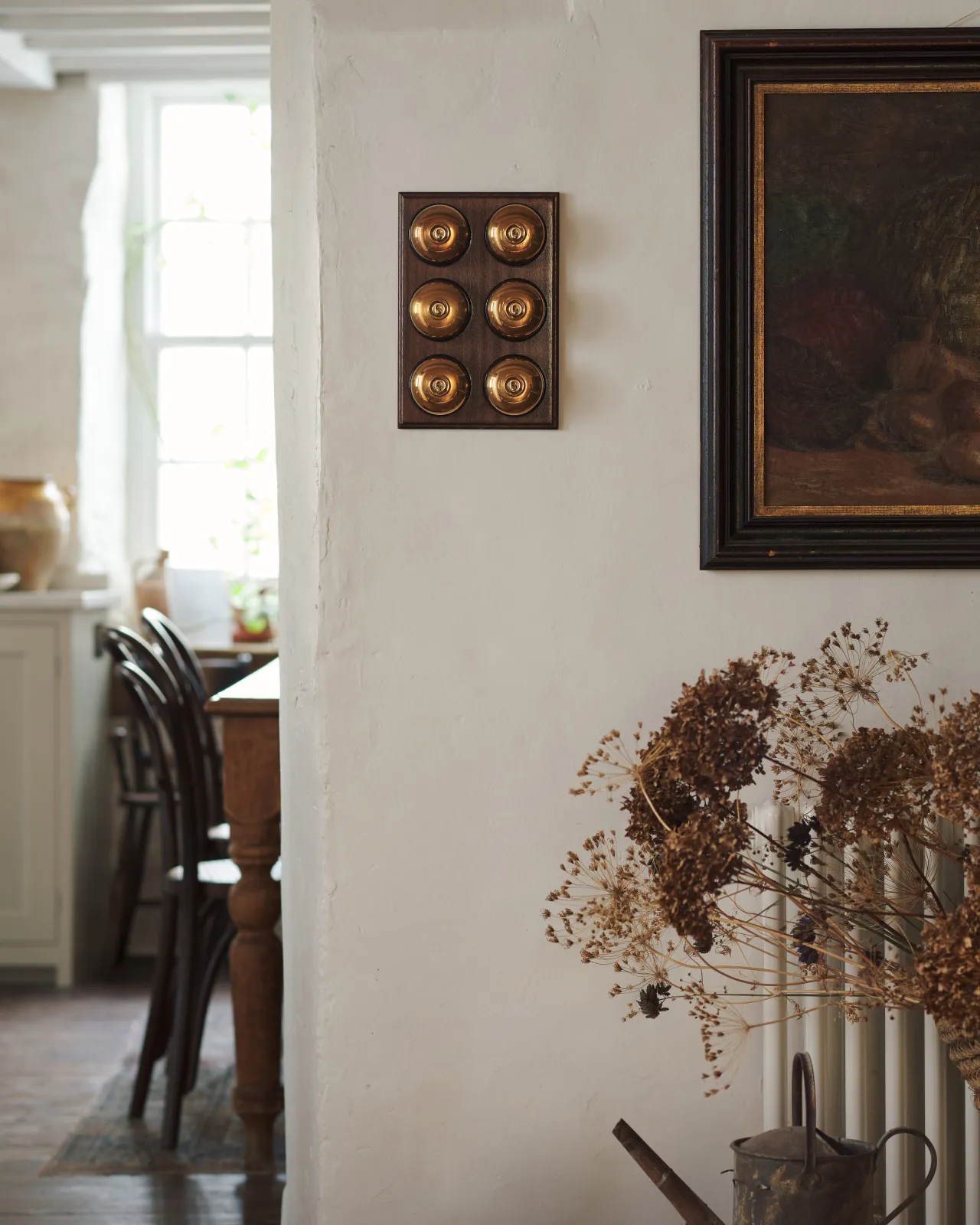 hes fitted to a richly stained Sapele pattress. Photographed in a cream-coloured room with painted Shaker cupboards.