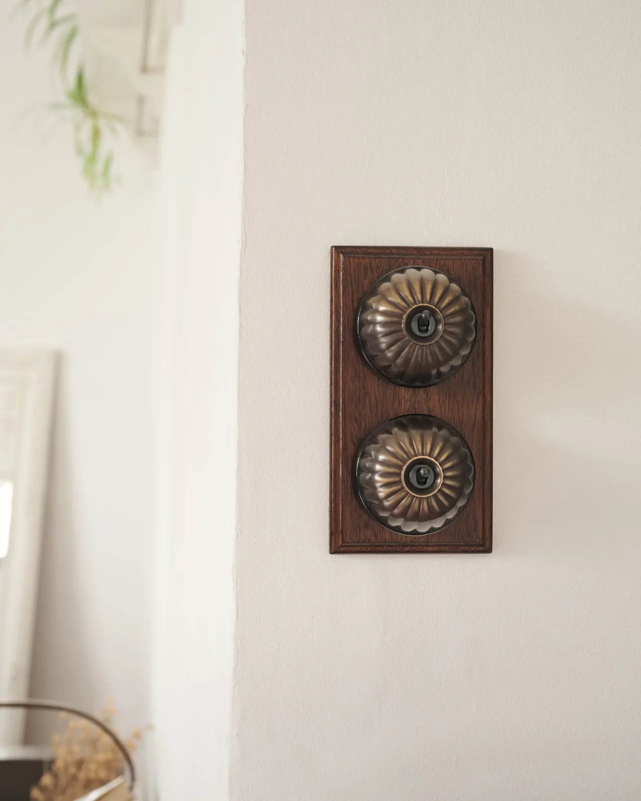 A pair of deVOL Jelly Toggle Switches in our 'Oxidised Brass' finish and fitted to a richly stained Sapele pattress.