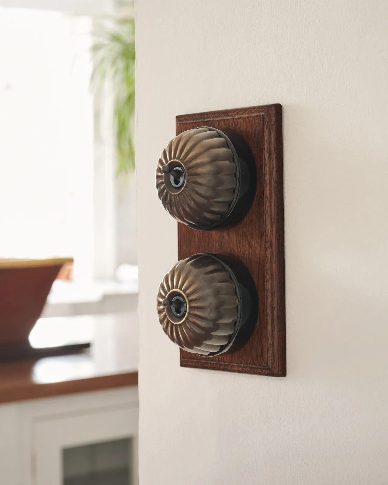 A pair of deVOL Jelly Toggle Switches in our 'Oxidised Brass' finish and fitted to a richly stained Sapele pattress.