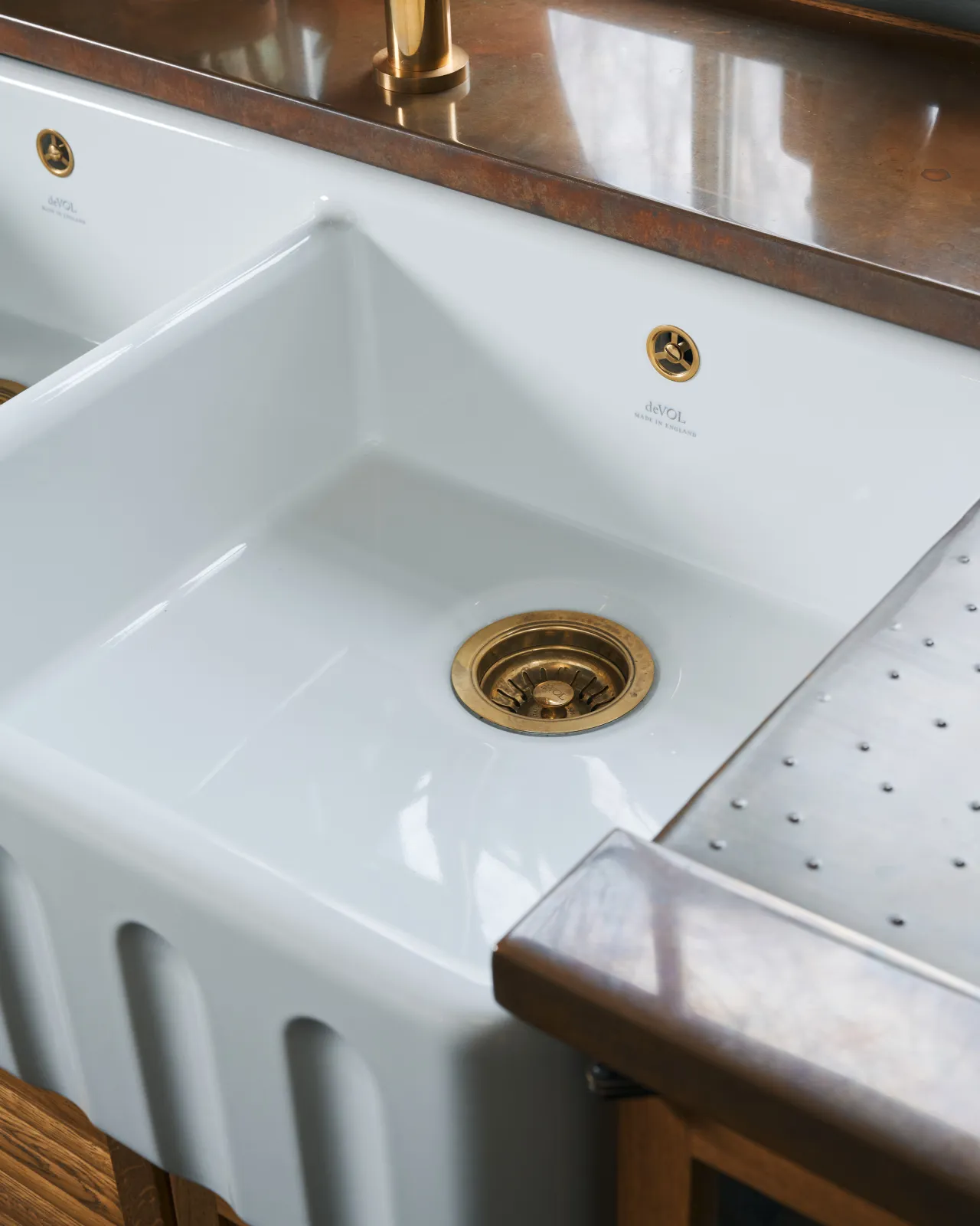 A close-up oblique view of the right-hand bowl of an extra large ceramic Belfast sink.