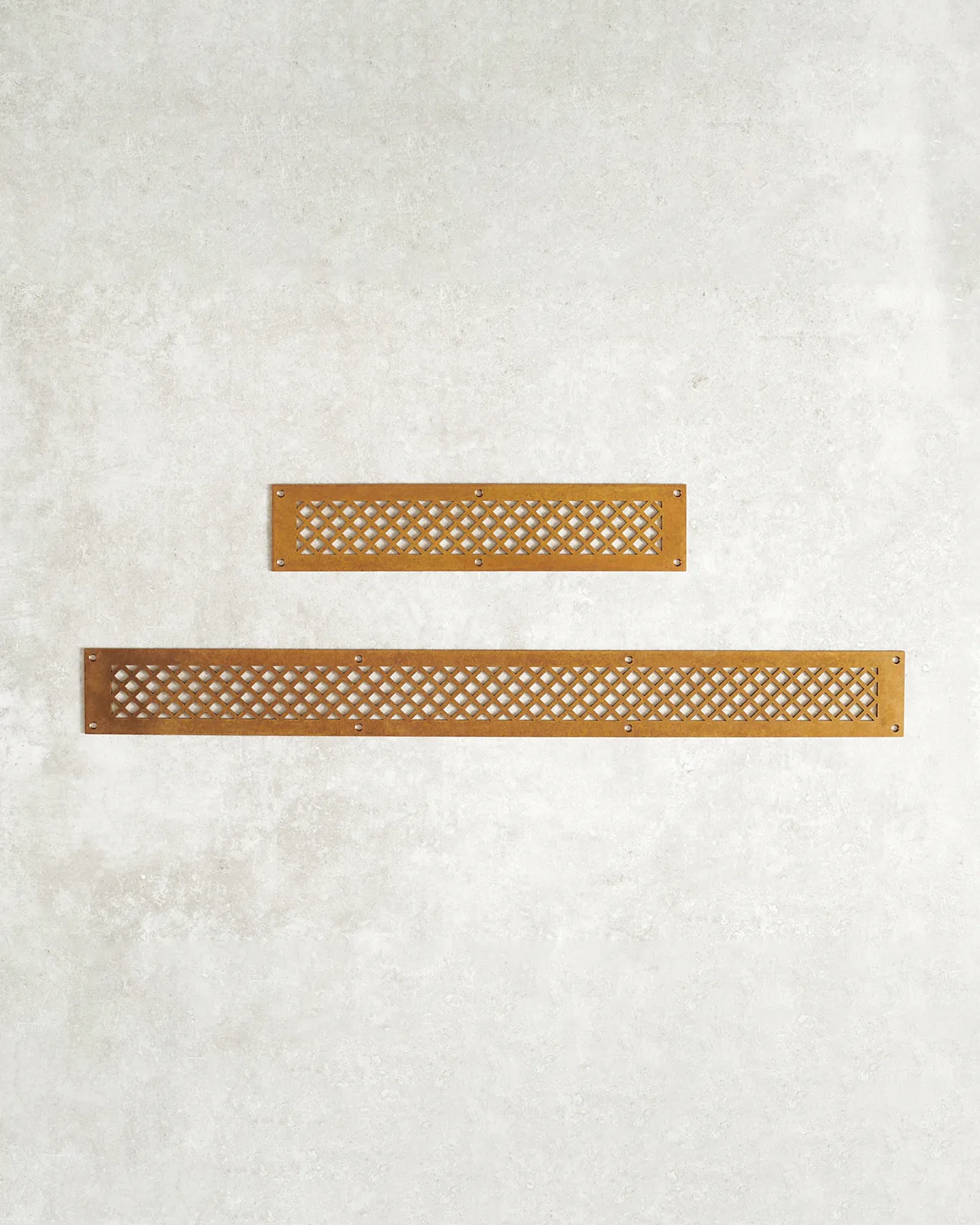 A classic ventilation cover with a diamond pattern cutout for integrated kitchen appliances in an aged brass finish, and shown in small and large lengths.