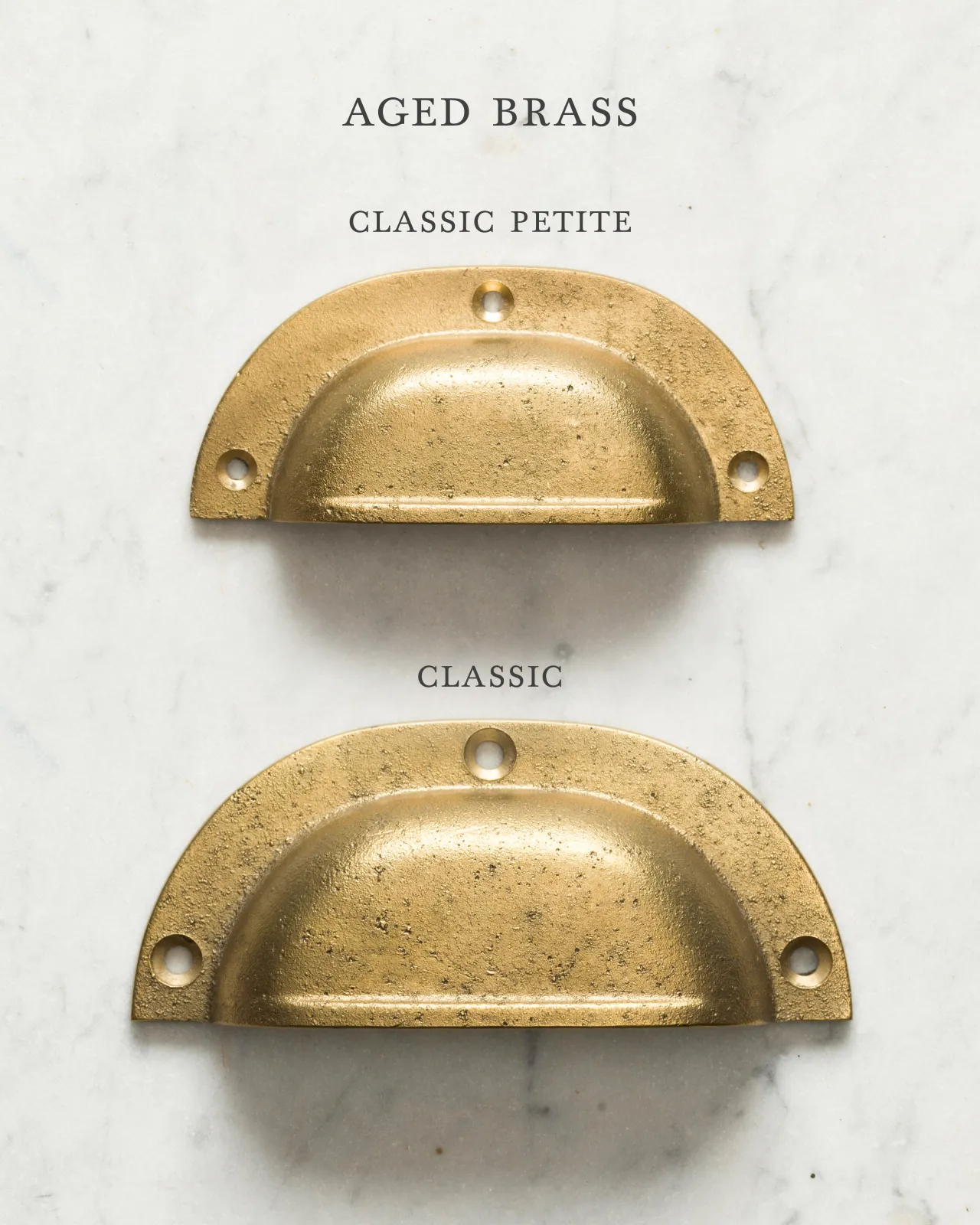 Two classic cup handles for a kitchen cupboard or drawer with an aged brass finish. There is a large and a small size.