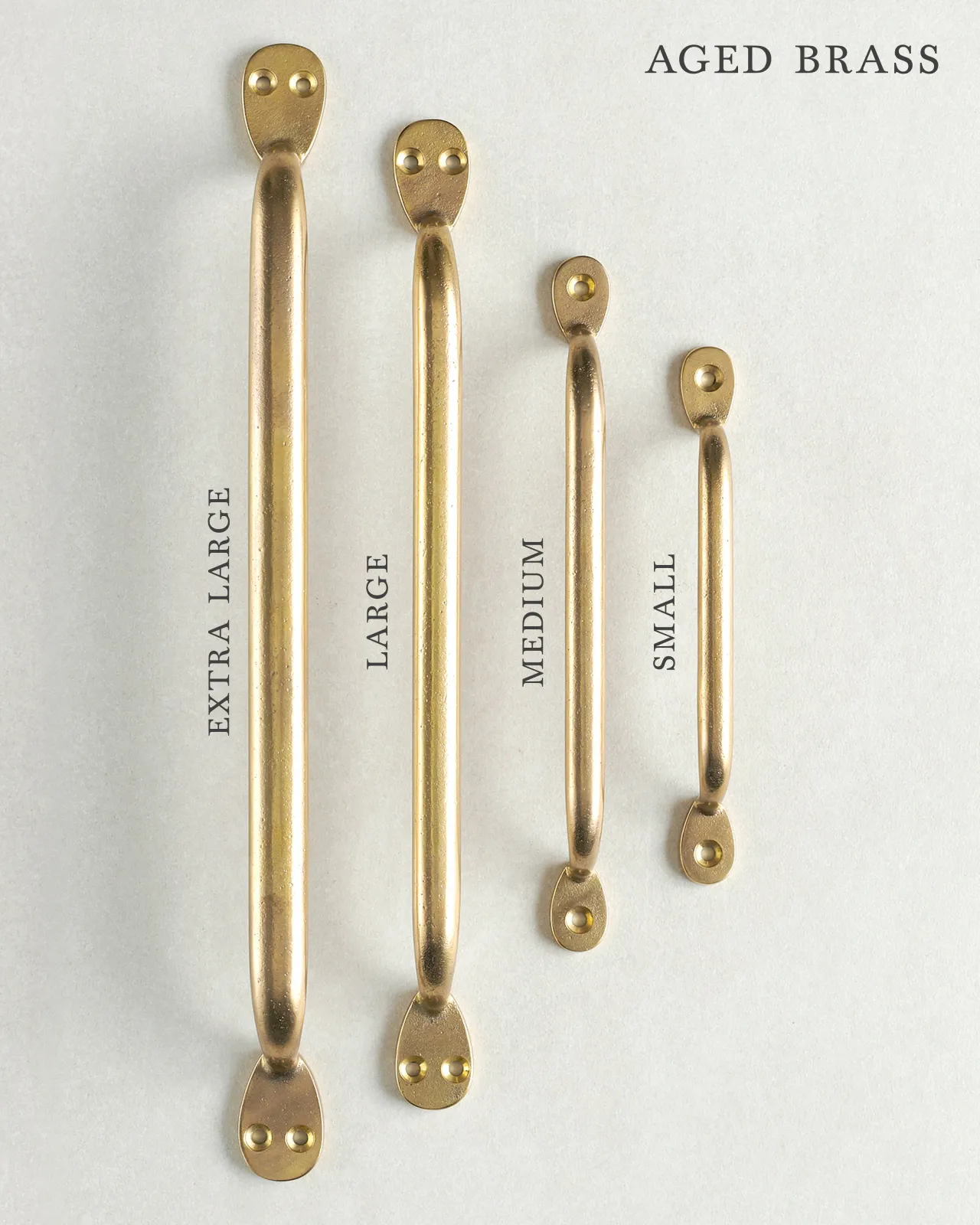 A collection of four classic pull handles for a kitchen cupboard or drawer with an aged brass finish. They range in size from ‘Extra Large’ to ‘Small’.