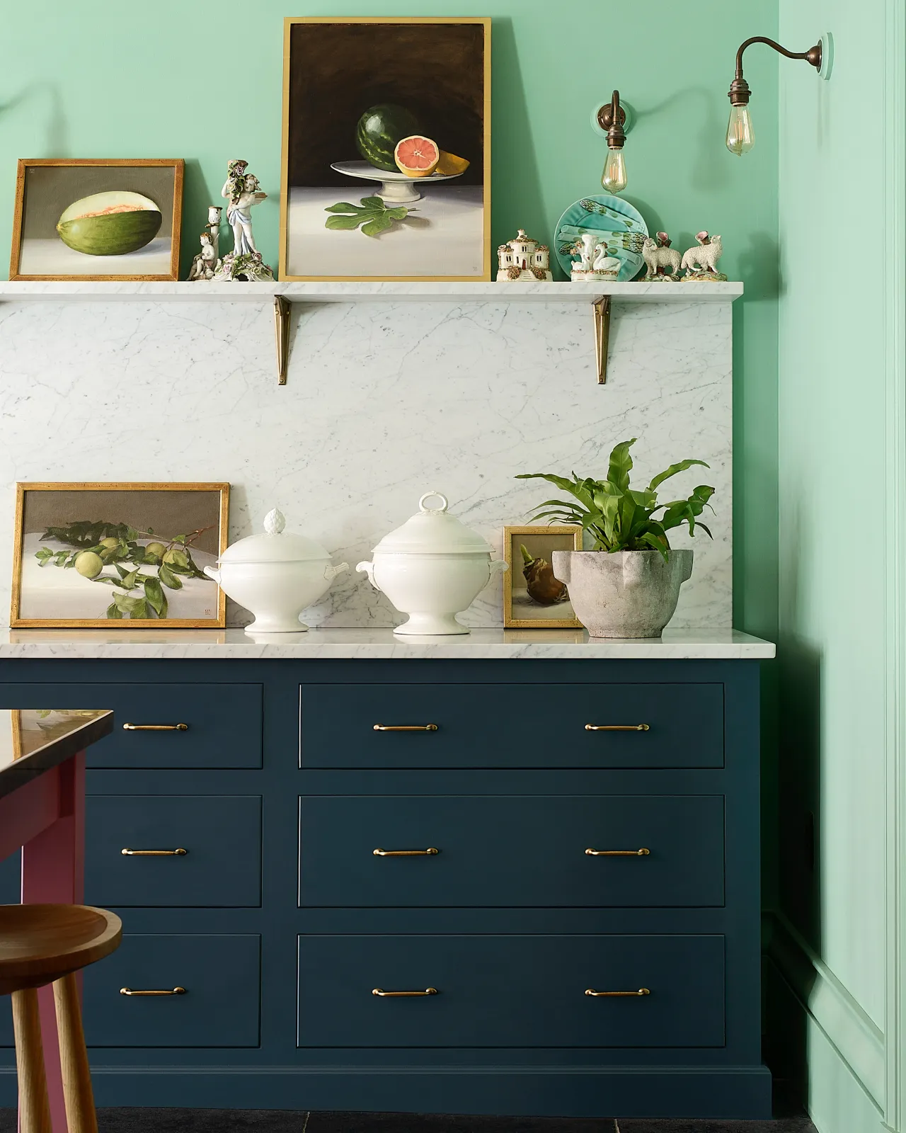 A straight-on view of royal blue painted Georgian-style kitchen pan drawers fitted with simple pull handles in a burnished 'Bella' brass finish.