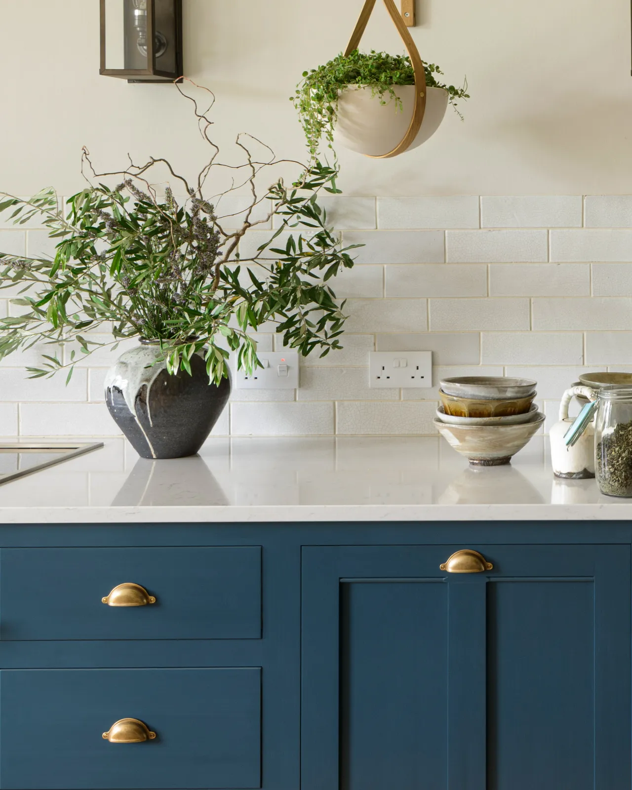 Royal blue painted Georgian-style kitchen cupboards, fitted with Georgian-style cup handles in a burnished 'Bella' brass finish.