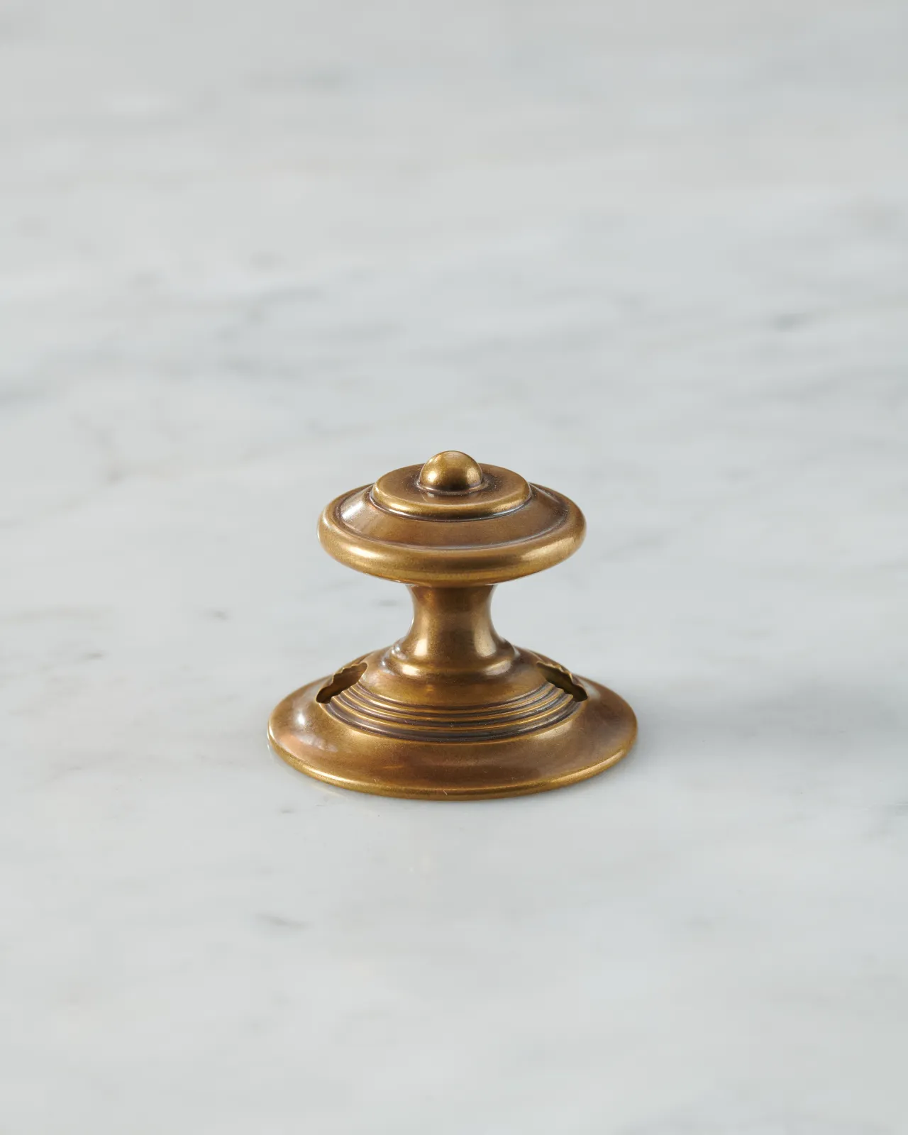 A Victorian-inspired ornate doorknob in a warm burnished brass finish.