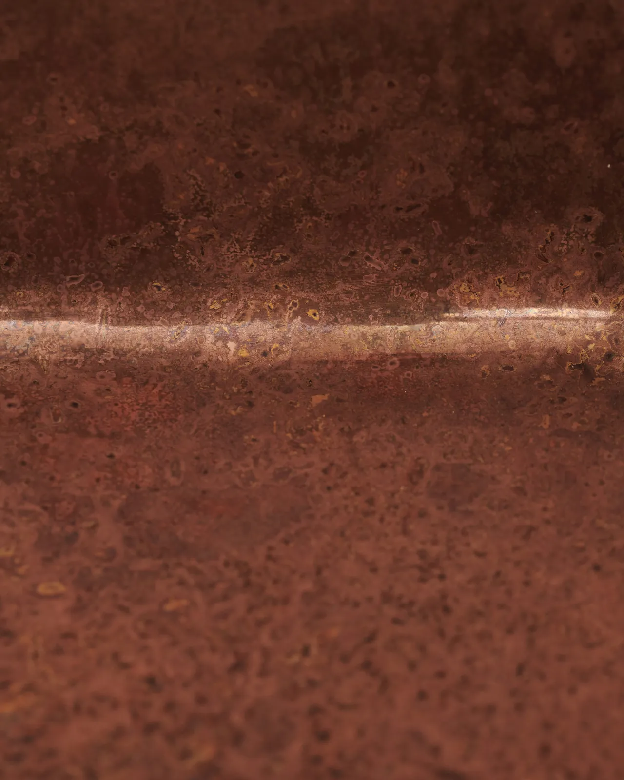 A close-up view of a mottled section of aged copper.