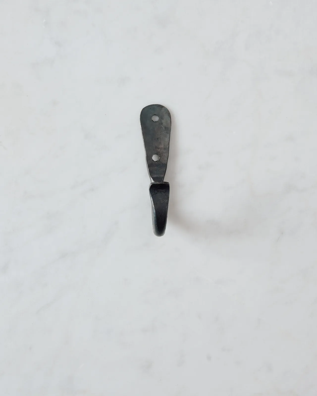 A front profile view of a large iron wall hook.