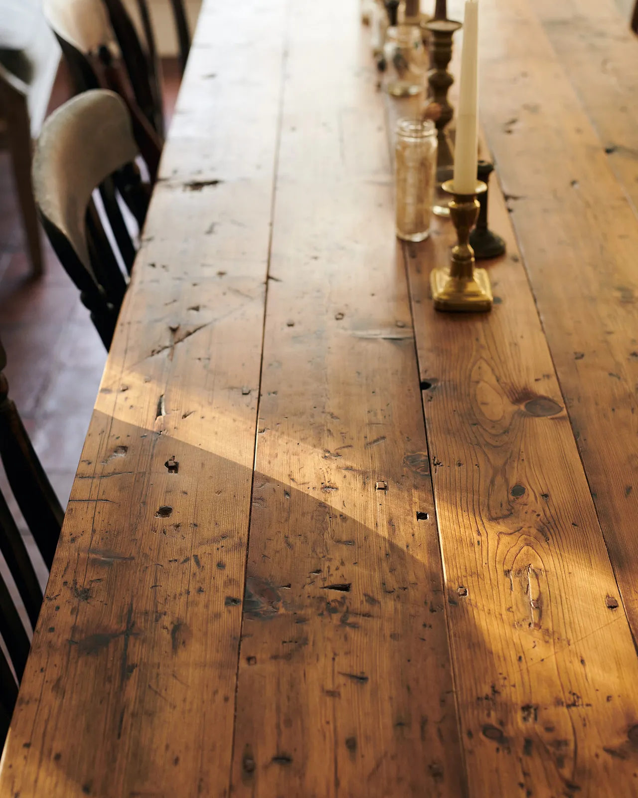 A close-up view of a rustic pine tabletop from a banquet-style dining table.