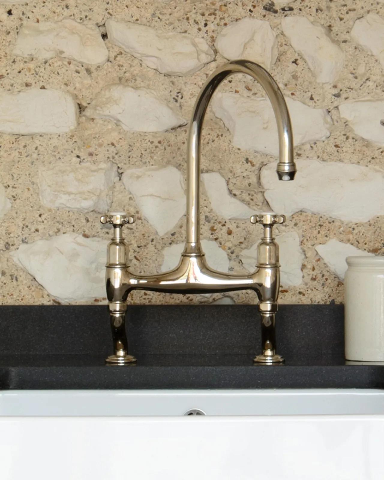 A close-up view of a traditional-style nickel mixer tap with crosshead handles.