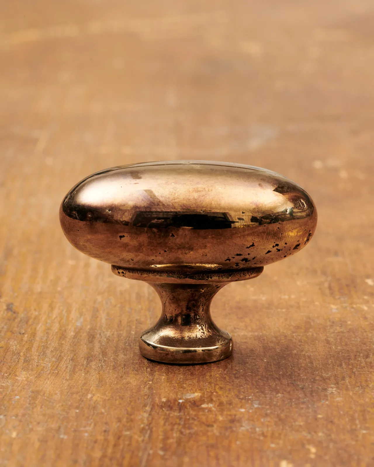 A ‘Large’ oval-shaped knob for a kitchen cupboard or drawer with a warm burnished brass finish.