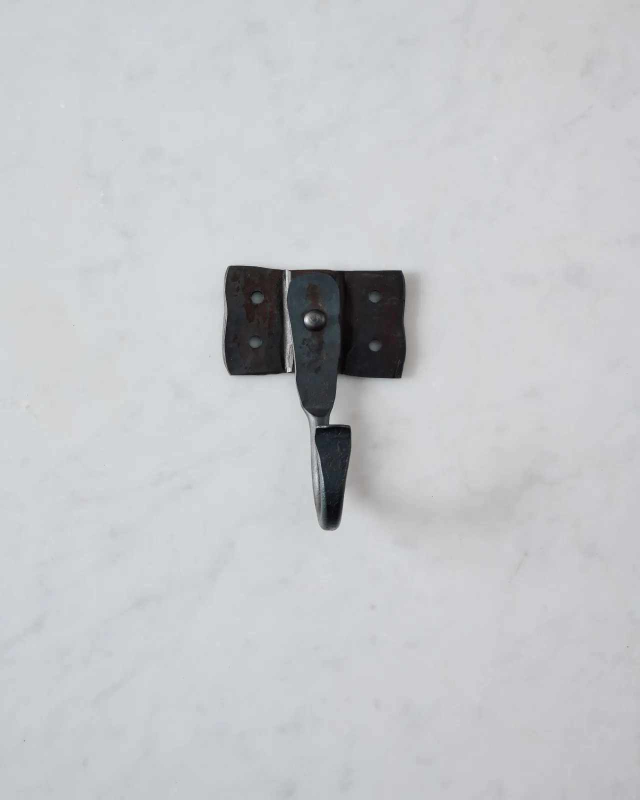 A front profile view of a large iron wall hook with a square-shaped backplate.