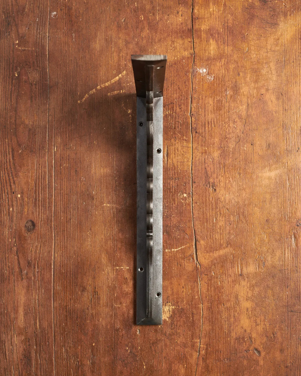 A front profile view of a large Victorian-inspired ornate shelf bracket in a cast iron finish.