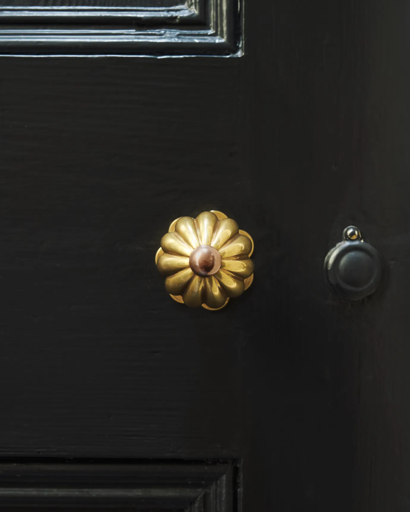 Marguerite Doorknob on a black door.