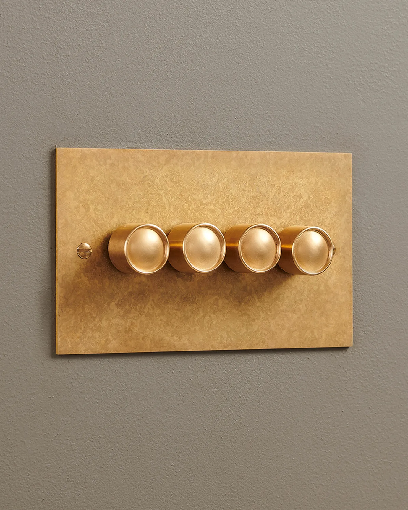 A 4 gang Classic Dimmer Switch in an Aged Brass finish.