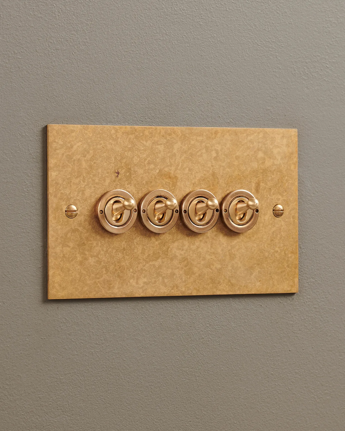 A 4 gang Classic Toggle Switch in an Aged Brass finish.