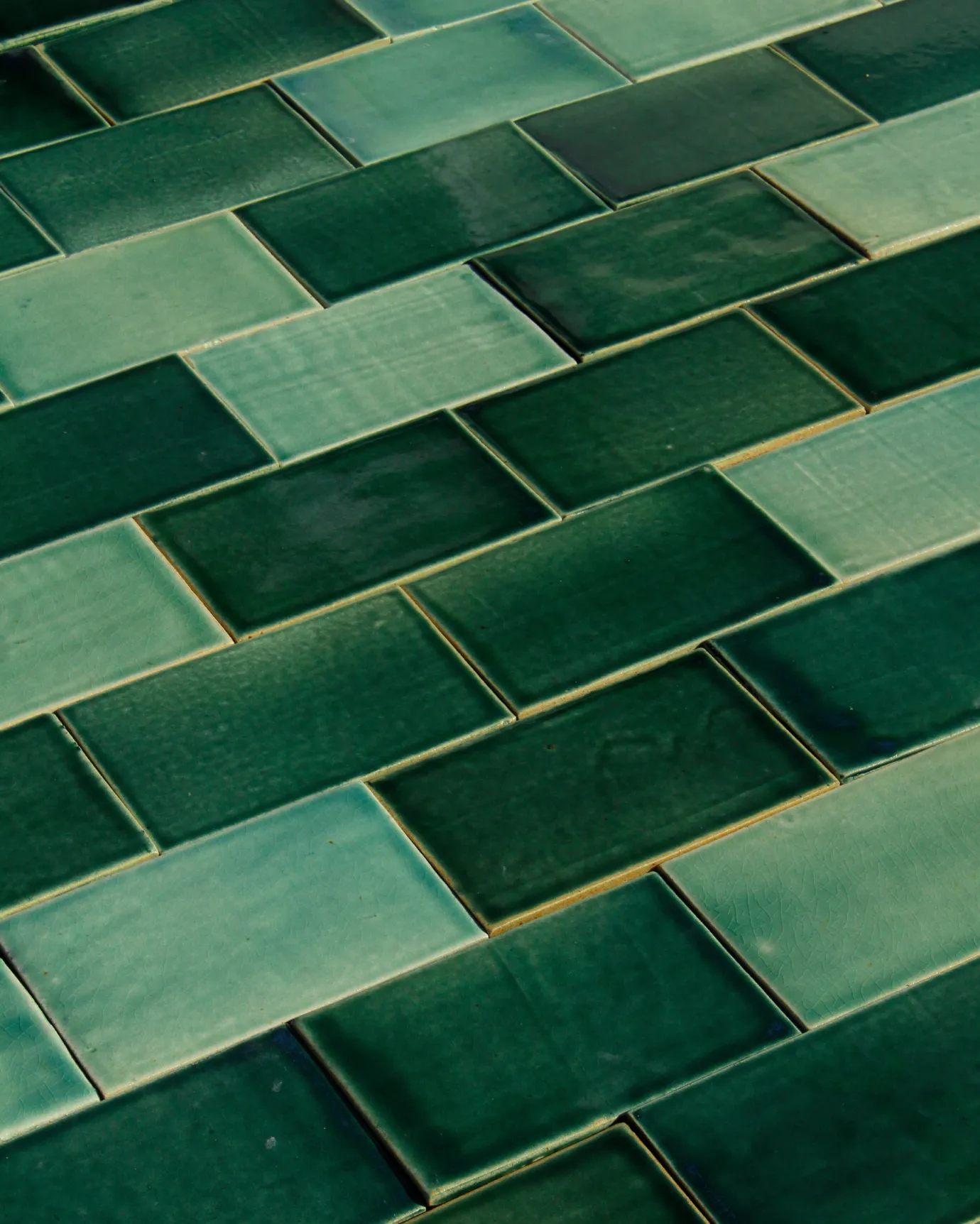 A close-up view of some handmade emerald green tiles.